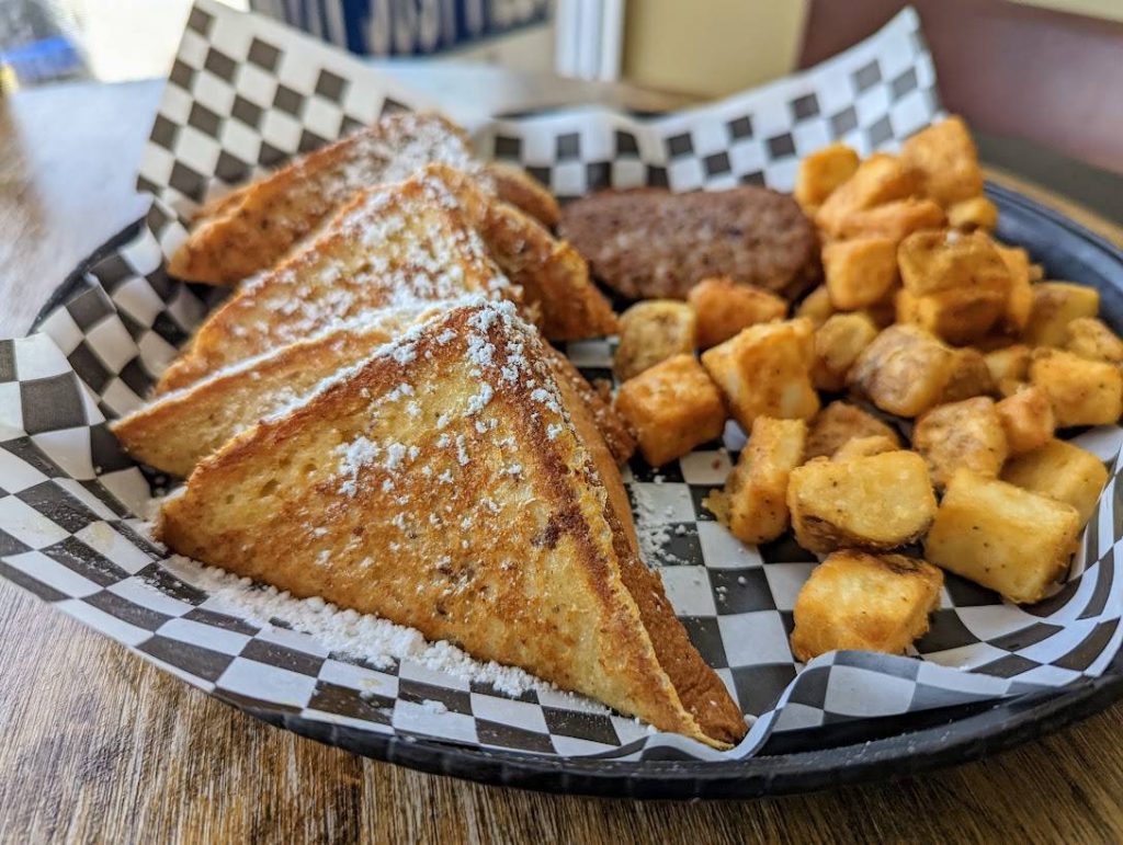 French toast and tater tots on a plate.
